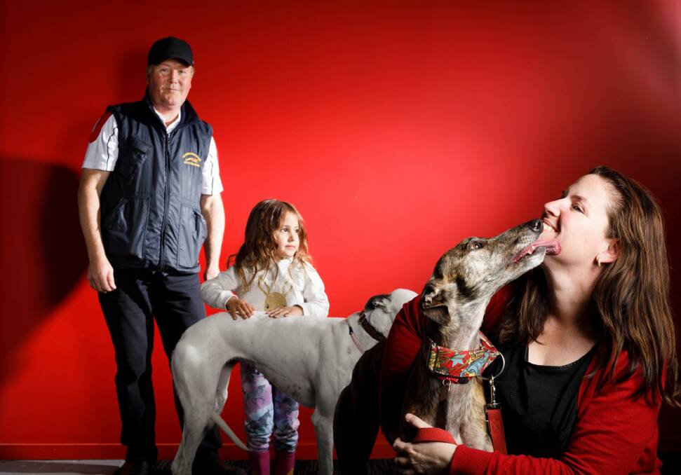 Chairman Canberra Greyhound Racing Club Alan Tutt, three-year-old greyhound fan Kree Gibbs, with retired greyhound Porsha, and Martina Taliano, co-ordinator of Canberra Region Greyhound Connections Group with retired greyhound Sadie.  Photo: Sitthixay Ditthavong