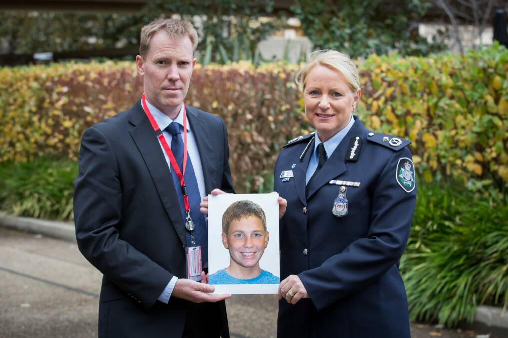 International Missing Children's Day family spokesperson Michael Macintosh, in Canberra with an age-progressed photograph of his missing son Mathieu-Pierre Macintosh, who would now be 13, with Australian Federal Police Assistant Commissioner Debbie Platz, National Manager Crime Operations. Photo: AFP