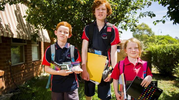 Laughlin, James and Eleanor McCooey with some of their school things ready for the new year at Amaroo School. Photo: Rohan Thomson