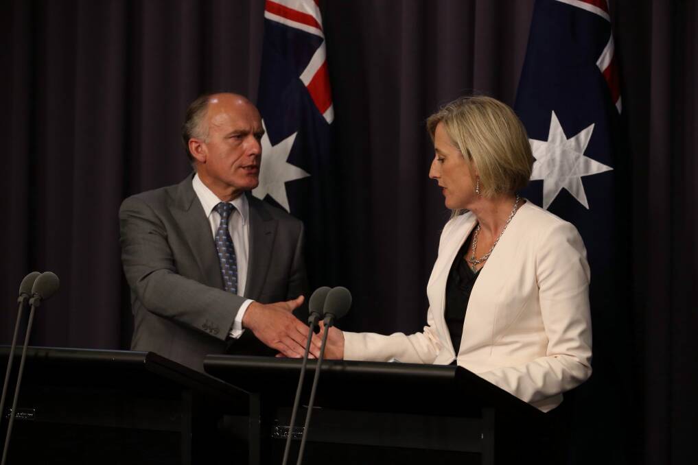 Deal: Employment Minister Eric Abetz and ACT Chief Minister Katy Gallagher agree to a Commonwealth loan of 1 billion for the demolition of asbestos filled houses in Canberra. Photo: Andrew Meares