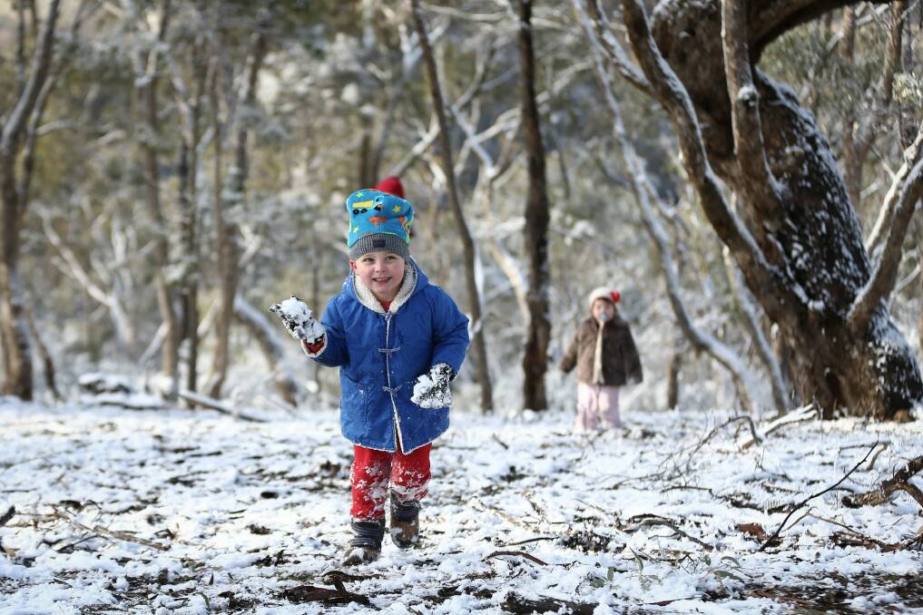 Four-year-old Max Richardson and one-year-old Rose Richardson at Mt Ainslie, which received snowfall in the early hours of the morning. Photo: Alex Ellinghausen