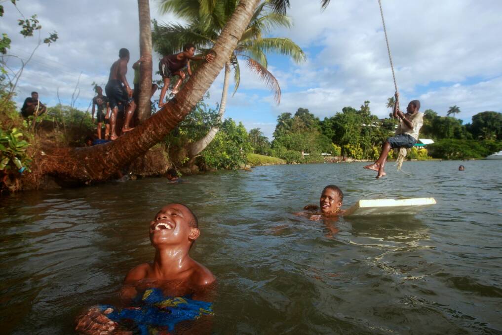 Children play in the water at Lami Bay, near Fiji's capital Suva. Photo: Alex Ellinghausen