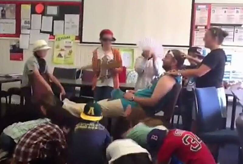 A still from the video where students are massaging former Caulfield Junior College teacher Chris Adams and bowing to him Photo: Supplied