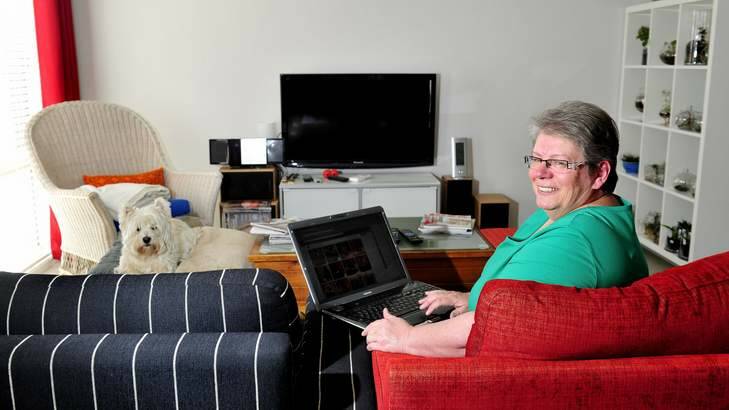 BITING THE BULLET: Annie Wyer, of Macgregor, who had the NBN installed in her home last year, says she hasn't looked back. Photo: Melissa Adams