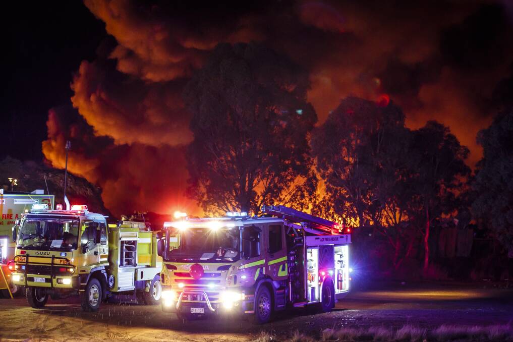 Emergency services work to put out a fire at a scrap yard in the industrial suburb of Beard, Queanbeyan, on Sunday night.  Photo: Sitthixay Ditthavong.