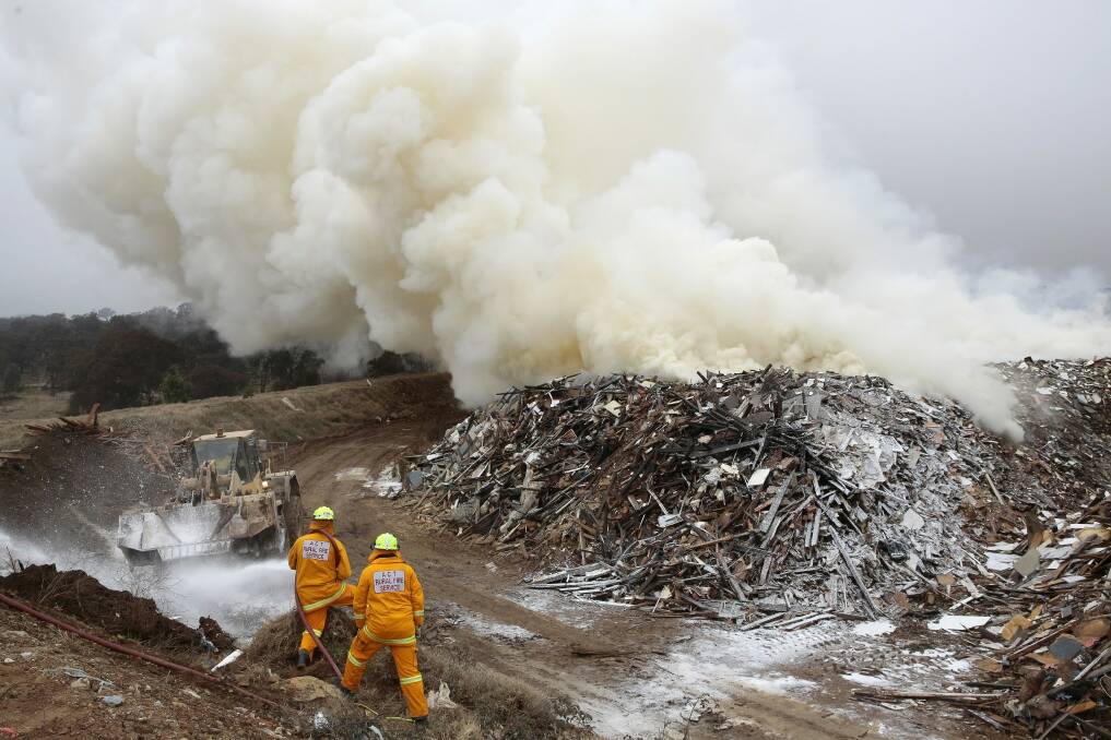 Crews from ACT Fire and Rescue and ACT Rural Fire Service at the scene of the fire in Pialligo. Photo: Jeffrey Chan