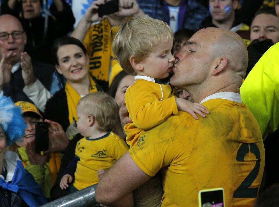 Proud dad: Australian captain Stephen Moore kisses his son Theodore after his team's 29-15 win over Argentina in their Rugby World Cup semi-final at Twickenham. Photo: Christophe Ena