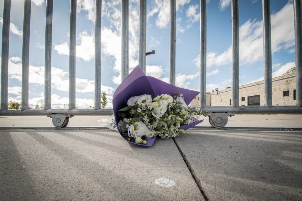A solitary bunch of flowers at the gate of the Islamic centre in Monash on Saturday following the terrorist attack in Christchurch.  Photo: Karleen Minney 