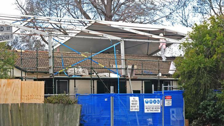 Workers wrap a plastic shield over a house in Downer for the safe removal of asbestos last year. Photo: Katherine Griffiths