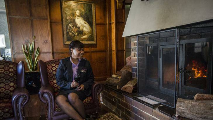 Nancy Alexander enjoys the fireplace at the Mercure Hotel Canberra Photo: Jamila Toderas