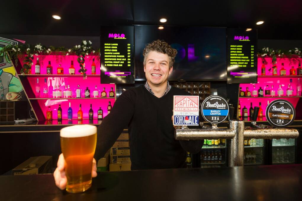 Molo Live manager Michael Duckworth behind the bar. Photo: Dion Georgopoulos
