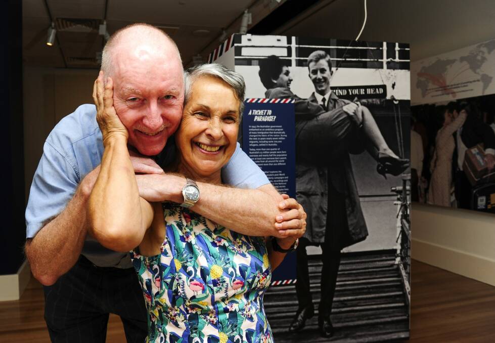 Brian and Visitacion Jonmundsson at the National Archives of Australia's exhibition in Canberra on Thursday, in front of the poster they helped create in 1963. Photo: Melissa Adams