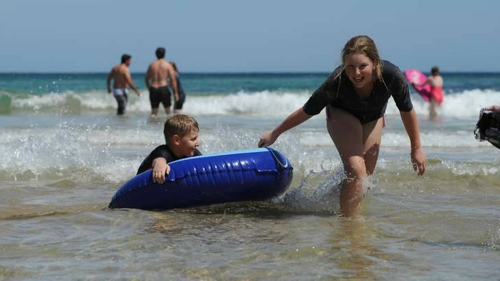 Enjoying the surf at South Broulee are Jacob, 10 and Claudia Kos, 11, from Deakin. Photo: Graham Tidy