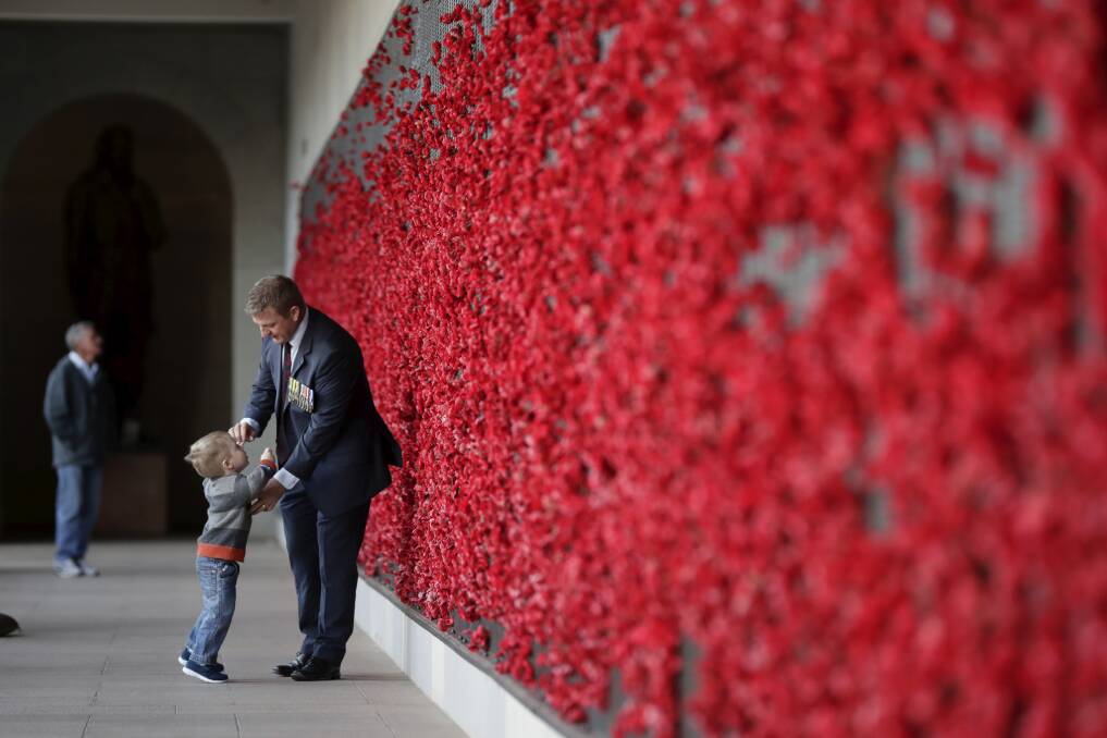Australian Army veteran Andrew with 2-year-old son Alexander after the Anzac Day dawn service at the Australian War Memorial. Photo: Alex Ellinghausen