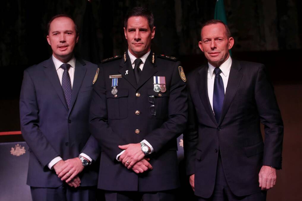 Australian Border Force commissioner Roman Quaedvlieg, centre, with Peter Dutton and then prime minister Tony Abbott. Photo: Andrew Meares