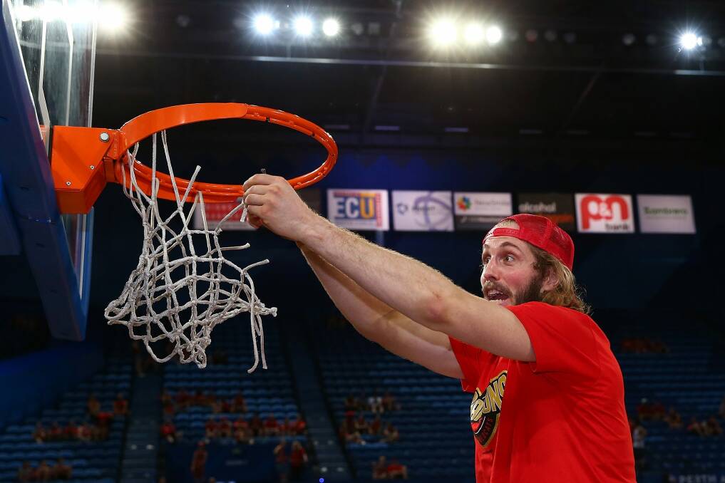 Jesse Wagstaff cuts the net after winning the NBL championship.  Photo: Getty Images