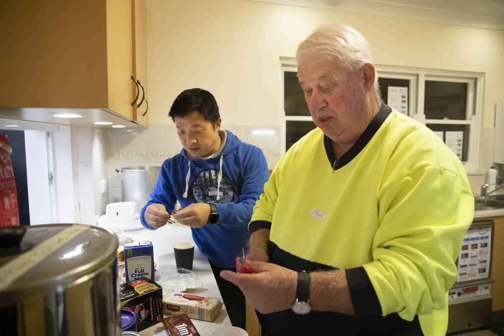 Safe Shelter volunteers  David Chang and Trevor Gilbert prepare refreshments at All Saints Church, Ainslie.  Photo: Sitthixay Ditthavong