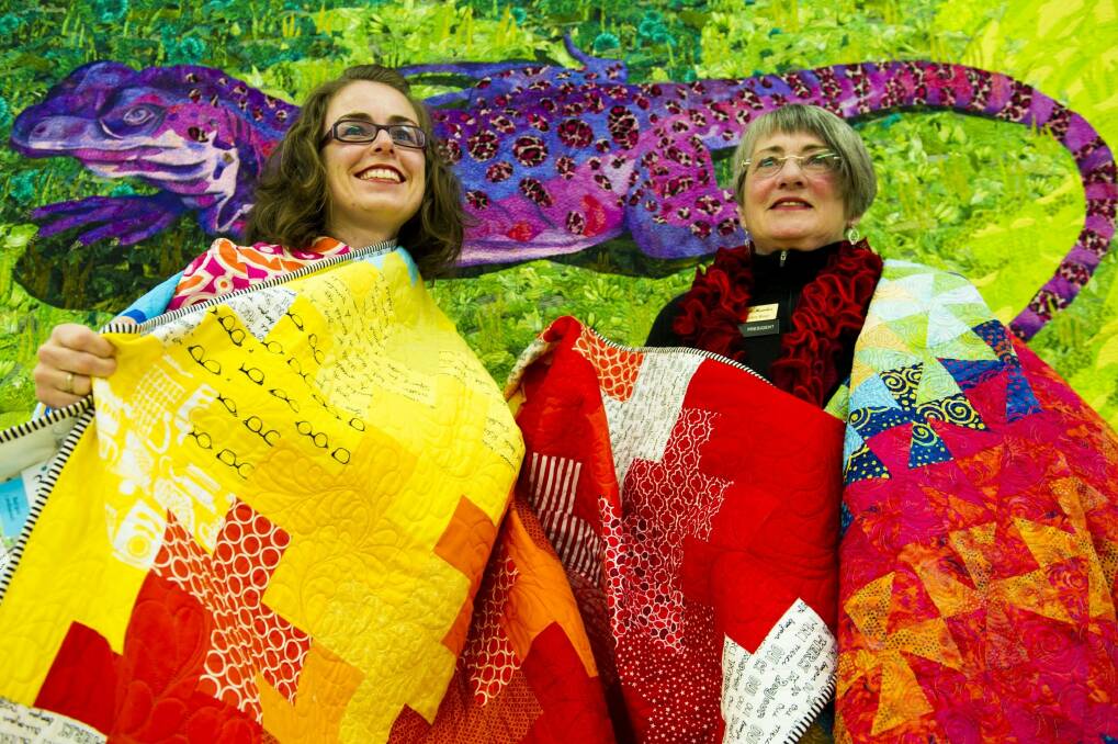 Canberra Quilters member Gemma Jackson, left, and president Helen Rose preparing for the quilt show. Photo: Jay Cronan