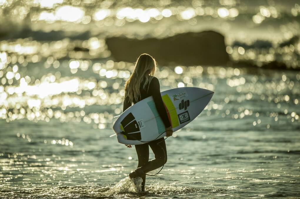 Sophia Fulton, 15, takes to the water under the watchful eye of coach and mentor surfing legend Pam Burridge. Photo: Karleen Minney
