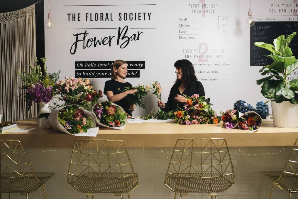 Customers are invited to take a seat at the Flower Bar and watch their floral creations be assembled in front of them. Photo: Rohan Thomson