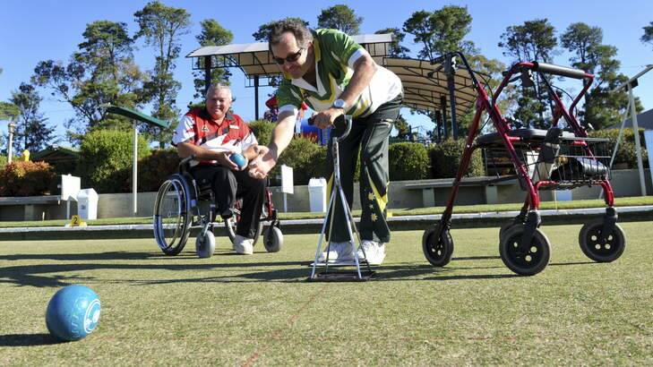 Disabled lawn bowlers prepare to represent the ACT in the National Championships in Victoria next month. Getting in some practice are Weston Creek bowler, John Mason (with walker) and Tuggeranong's Kevin Yovanitch (wheelchair). Photo: Graham Tidy