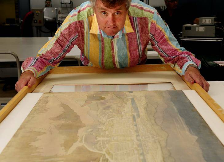 Assistant driector preservation at the National Archives, Ian Batterham with original entries of Burley Griffin's Canberra Design entries. Photo: Melissa Adams MLA