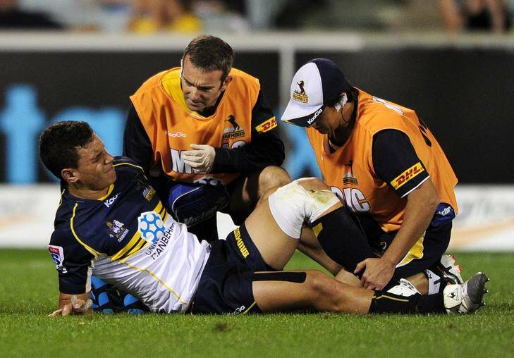 Matt Toomua in distress after rupturing his ACL against the Sharks on Saturday night. Photo: Stuart Walmsley