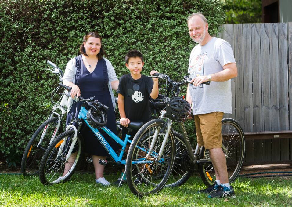 Serina Bird with son Austin, 9, and husband Neil Hadley. The family likes to go for a bike ride for a cheap day out. (Her other son Audie, 6, was a little camera shy.) Photo: Elesa Kurtz