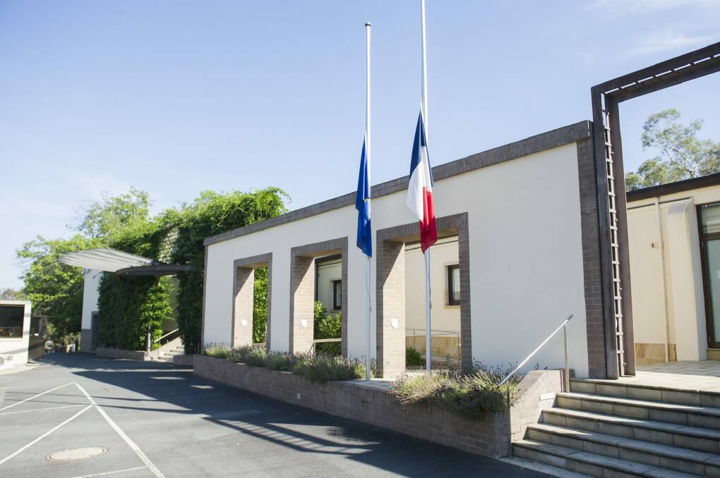 In shock: Flags at the French embassy at Yarralumla fly at half mast on Thursday morning. Photo: Rohan Thomson