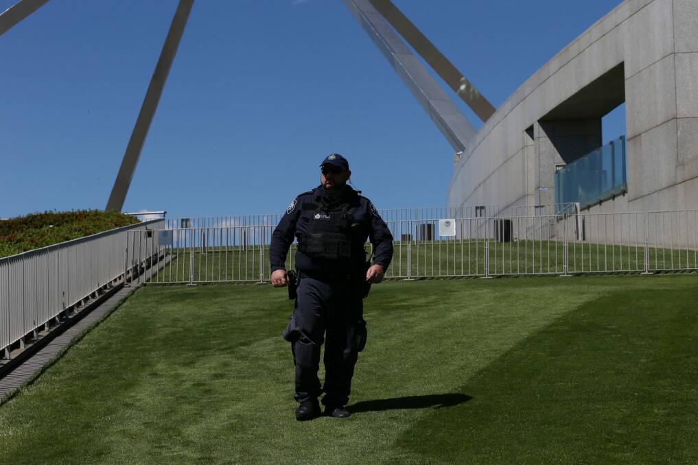 A security guard patrols the lawns at Parliament House. Photo: Andrew Meares