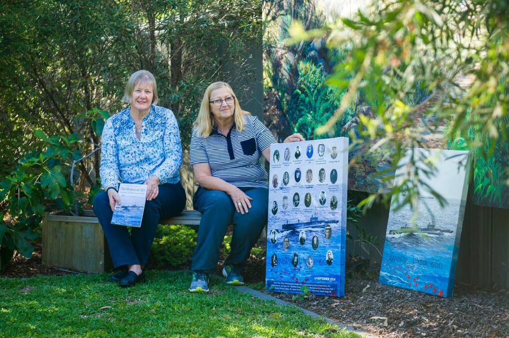 Author Dr Kathryn Spurling, who wrote Mystery of AE1, Australia's lost submarine and crew, and artist Margaret Hadfield with her painting Known Unto God AE1. The pair are quietly commemorating the submarine's discovery. Photo: Dion Georgopoulos
