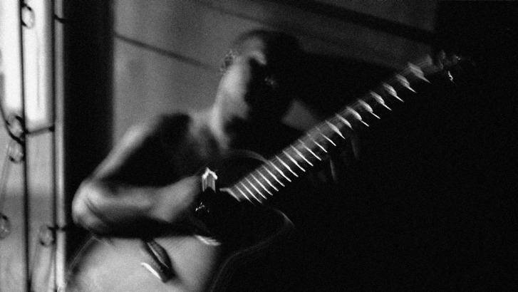 "Johnny playing guitar, Port Moresby, PNG" by Sean Davey. Photo: supplied