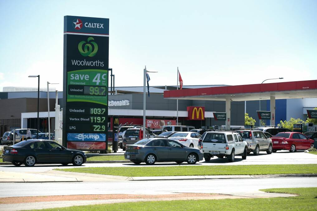 Cars line up for discounted fuel at Caltex/Woolworths Petrol in Majura Park. Photo: Jeffrey Chan