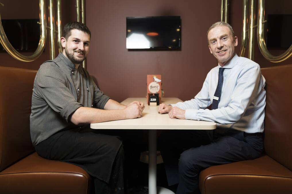 Woden Central executive chef Nick Wren (left) and general manager Matt Walshe sit in the old red booths from Henry's restaurant. Photo: Lawrence Atkin