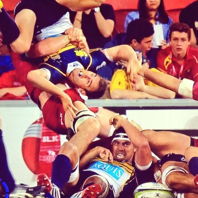 Brumbies halfback Nic White is flipped by Queensland Reds flanker Liam Gill. Photo: Twitter