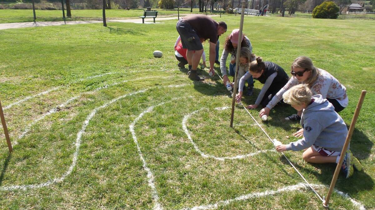 A group of Yass artists trial their labyrinth design with flour. Photo: Sean Haylan