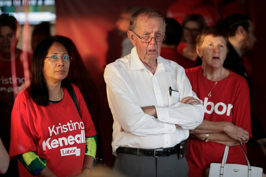 Labor supporters watching the news on television as the results roll in. Photo: Alex Ellinghausen