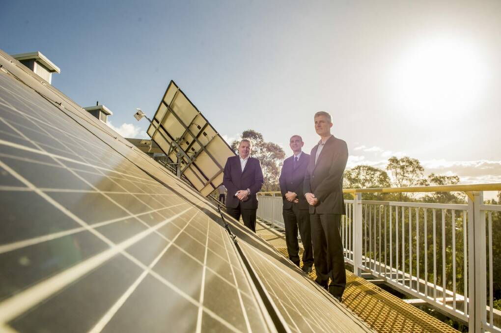 IT Power managing director Simon Troman, CIT corporate services manager facilities Ivan Radic and Ivor Frischknecht of Australian Renewable Energy Agency after receiving $405,000 from ARENA for a three-year trial of lithium-ion batteries. Photo: Jay Cronan