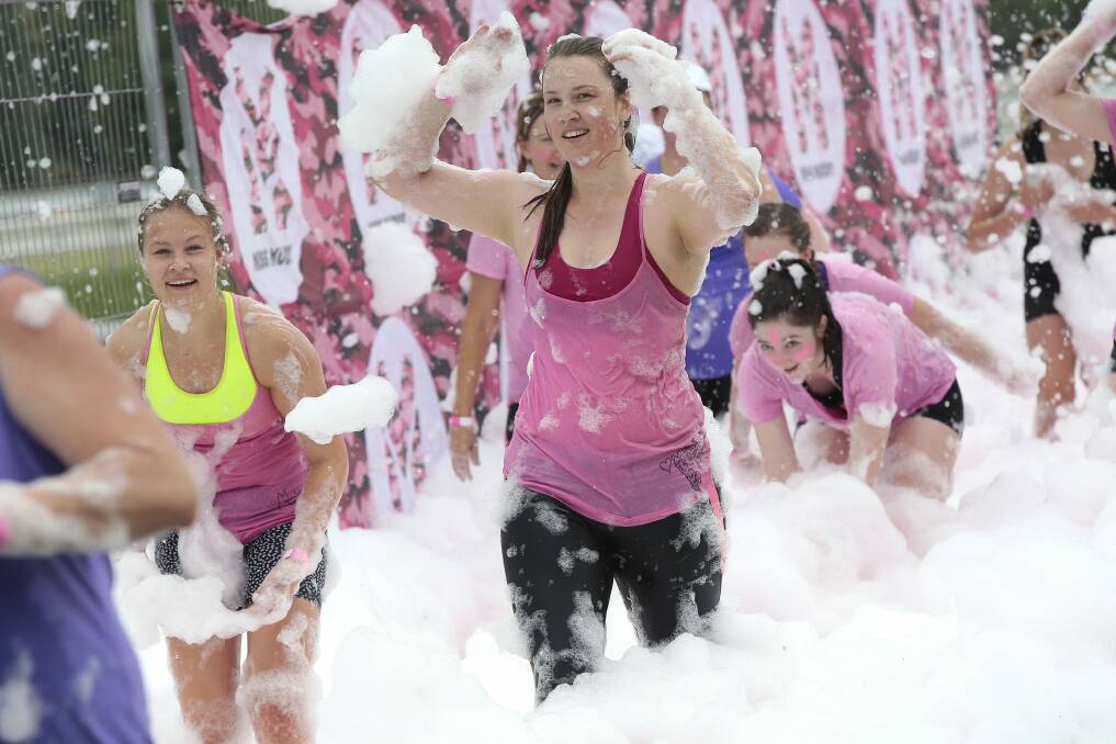 Runners have fun with foam on the obstacle course. Photo: Jeffrey Chan