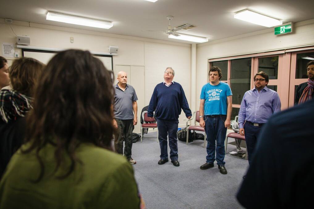 Arts reporter Ron Cerabona, centre, in blue jumper,  joins in with vocal warm-ups at the National Acting School in Dickson.  Photo: Sitthixay Ditthavong