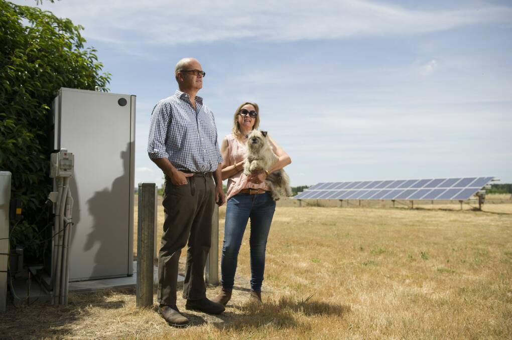 Dominic and Jane Osborne with solar array and battery storage pack. Photo: Jay Cronan
