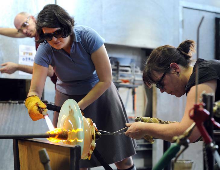 Glass artists at work in the hot shop, create a pavlova. Calling themselves "Bleorge" are Mel George, left and Annette Blair. Photo: Graham Tidy