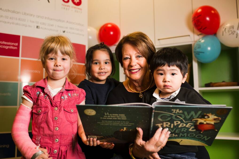 Lady Cosgrove read 'The Cow Tripped Over the Moon' during the 2017 National Simultaneous Story Time. From left, Alice Street 4, Emily Grbic 4, Lady Cosgrove, and Ethan Ng 3. Photo: Jamila Toderas