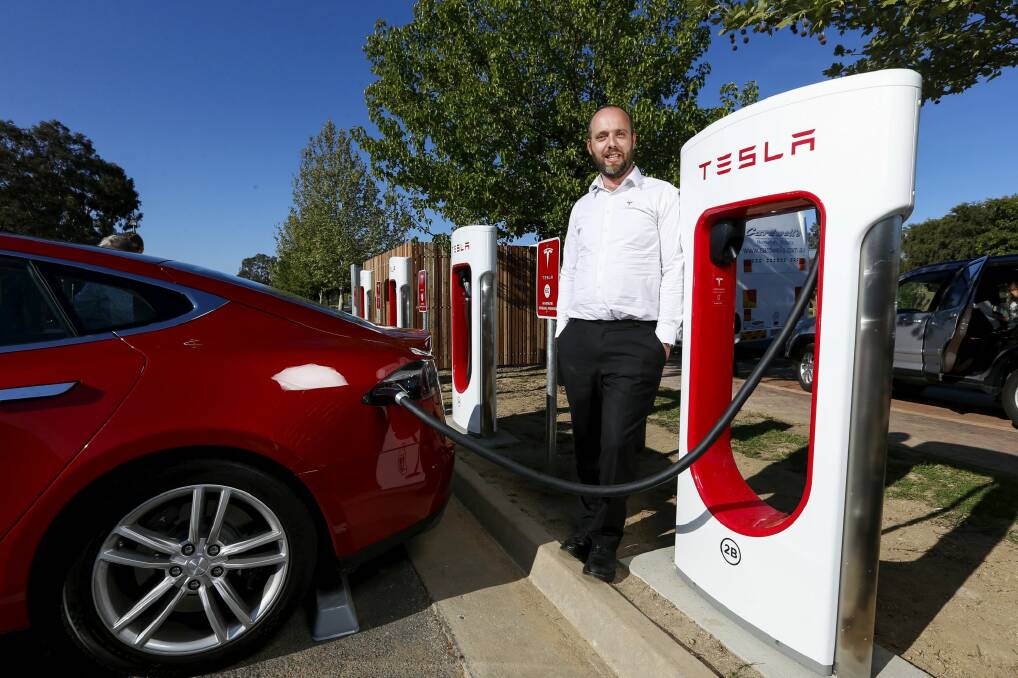 Tesla Supercharger program manager Evan Beaver at the charge station in Wodonga, Victoria. Photo: Mark Jesser