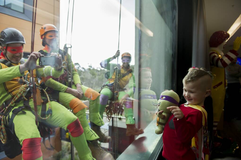 Ninja turtles fan Mason was among children delighted by the outdoor antics of window washers including Marc Larouche, Tim Booth and Reece Stevens at Ronald McDonald House.
 
 Photo: Jay Cronan