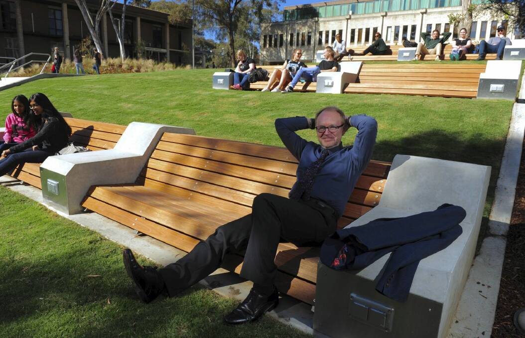 The University of Canberra's Vice-Chancellor Stephen Parker relaxes on the newly landscaped concourse. 

 Photo: Graham Tidy