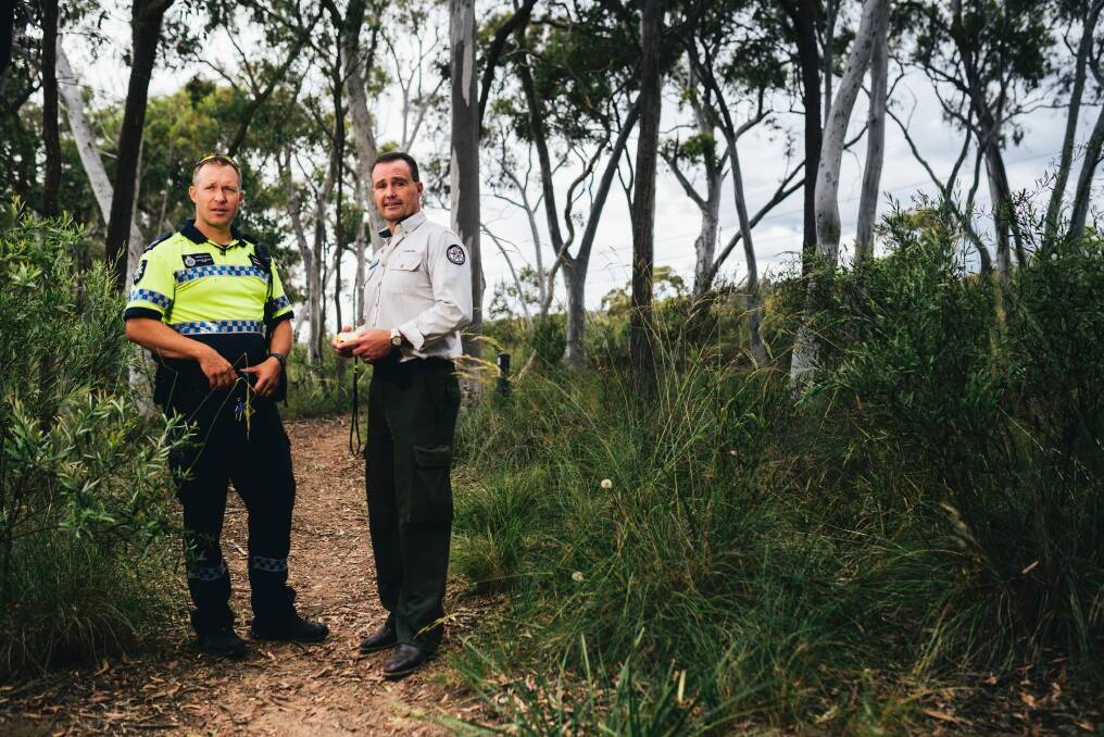 ACT Specialist response group Lauchlan Ryan and National Parks' Brett McNamara discussing the advantages of carrying a personal locator beacon (PLB). Photo: Rohan Thomson