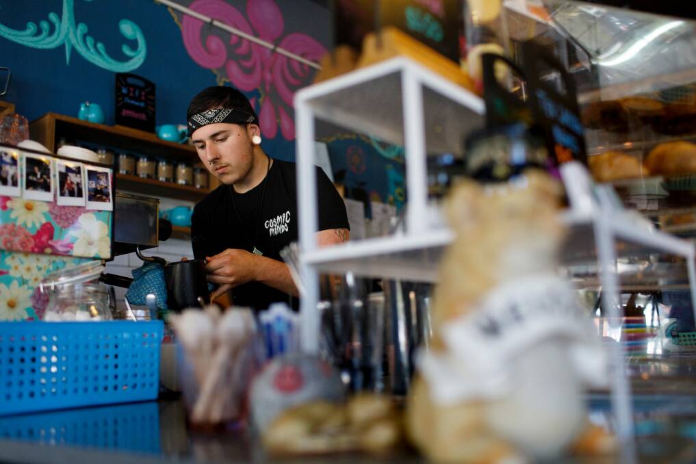Barista Zac Jarvis working in Little Oink at the Cook shops. This buzzing cafe has thrived despite growing pressure from larger shopping precincts, while others haven't been so lucky. Photo: Sitthixay Ditthavong