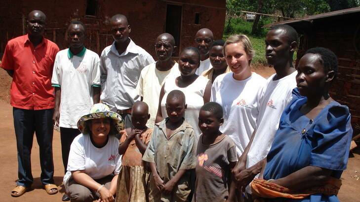 Kamalini Lokuge, wearing the hat, with other  Médecins Sans Frontières volunteers and a family in Uganda who lost 11 members to the deadly virus.