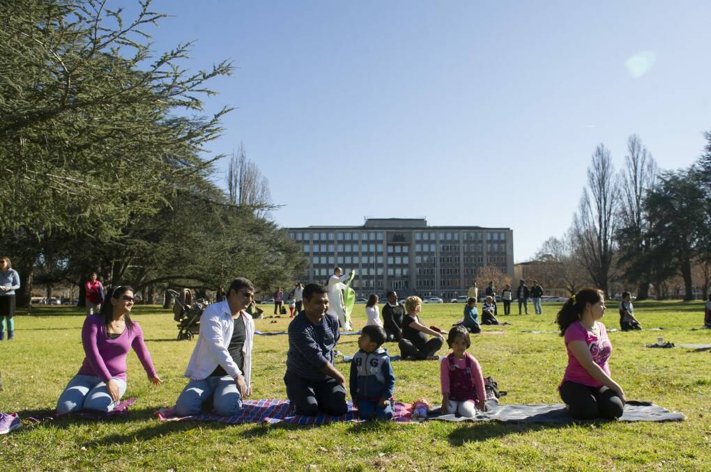 Praksh Penchl and his family participate in an outdoor yoga class to mark the official International Day of Yoga. Photo: Jay Cronan